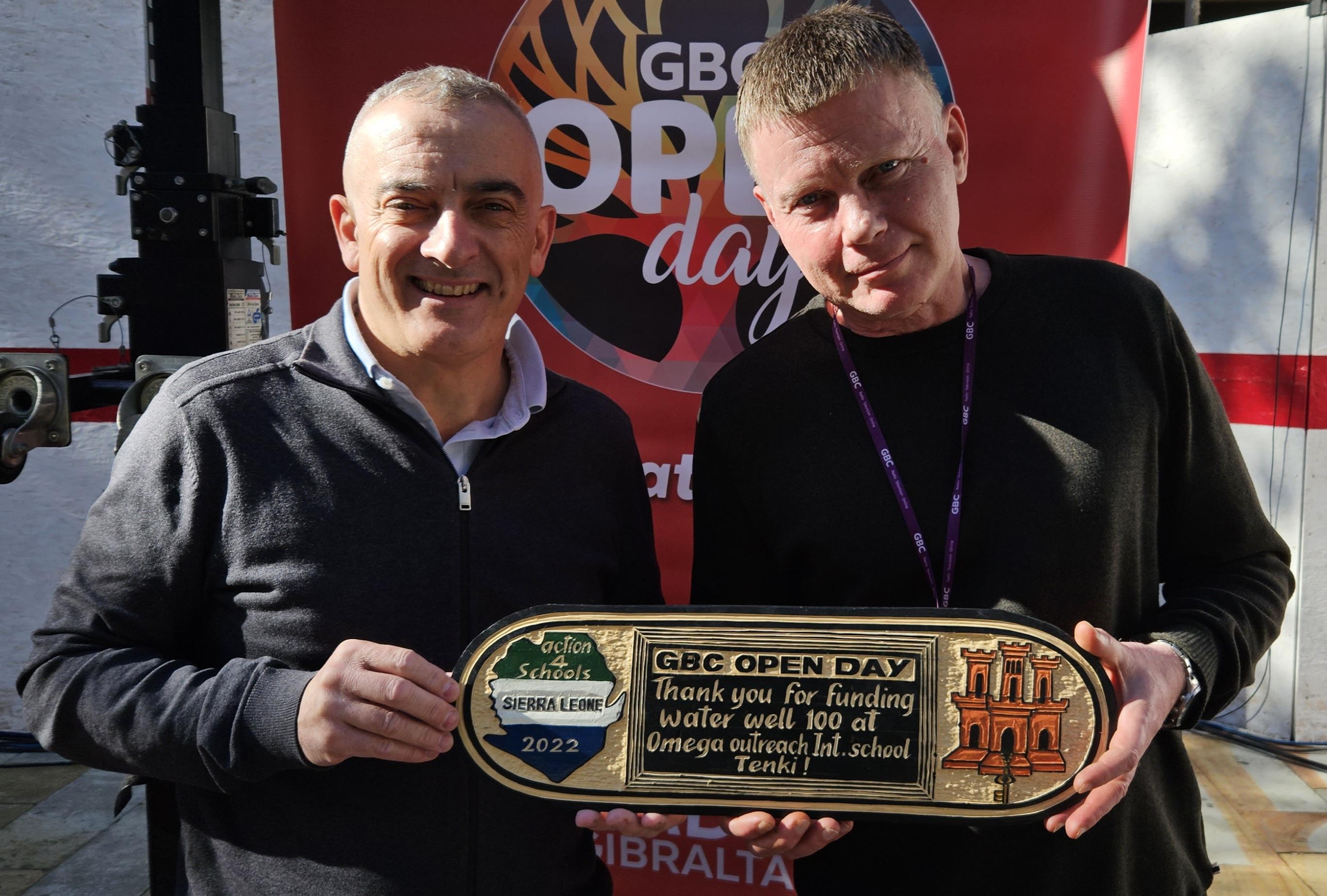 Plaque for well 100 presented to Ian Daniels Head of GBC Radio on GBC Open Day 2023 by Jimmy Bruzon Founder of Action4schools-Sierra Leone charity