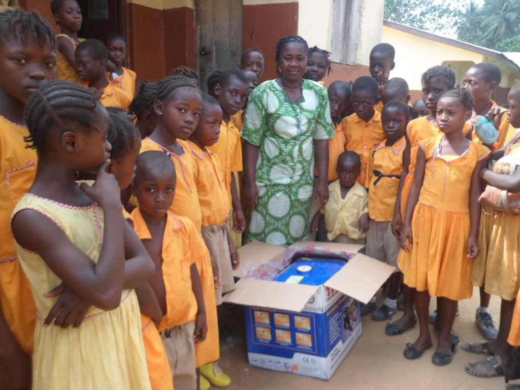 Head teacher & sch. children received new generator donated by AKIN Gibraltar