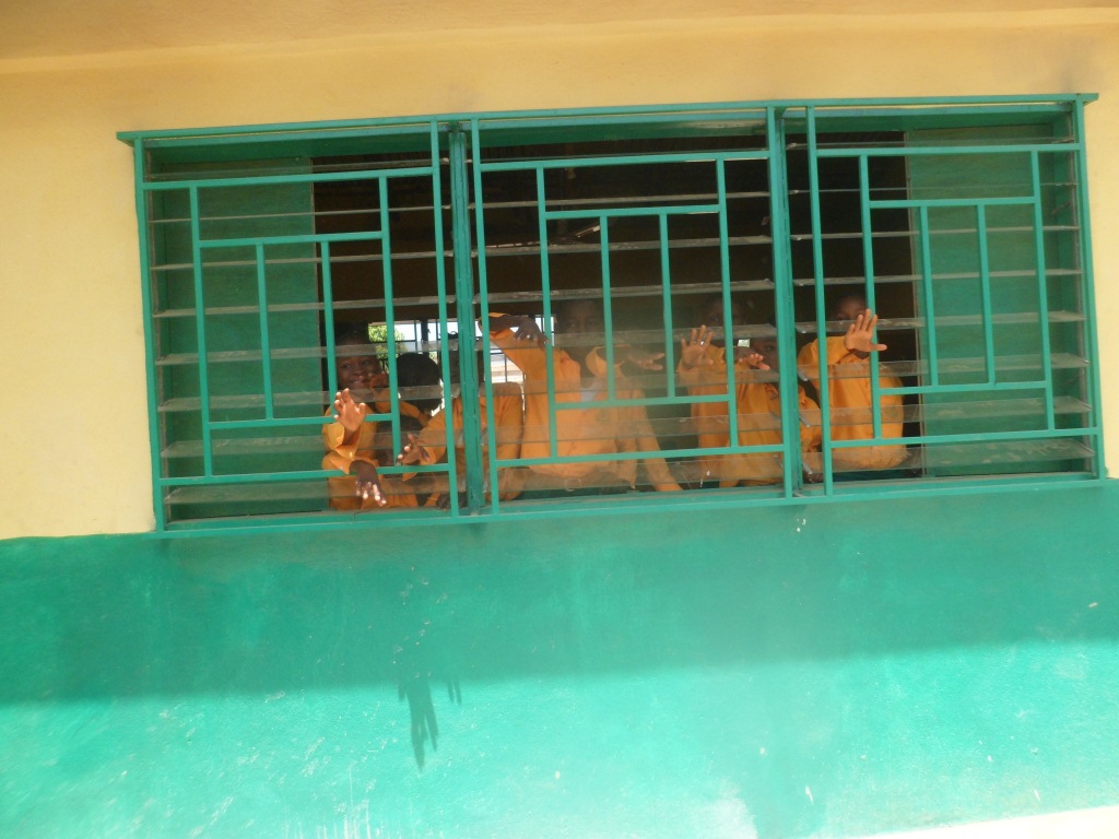 School pupils waving through the window