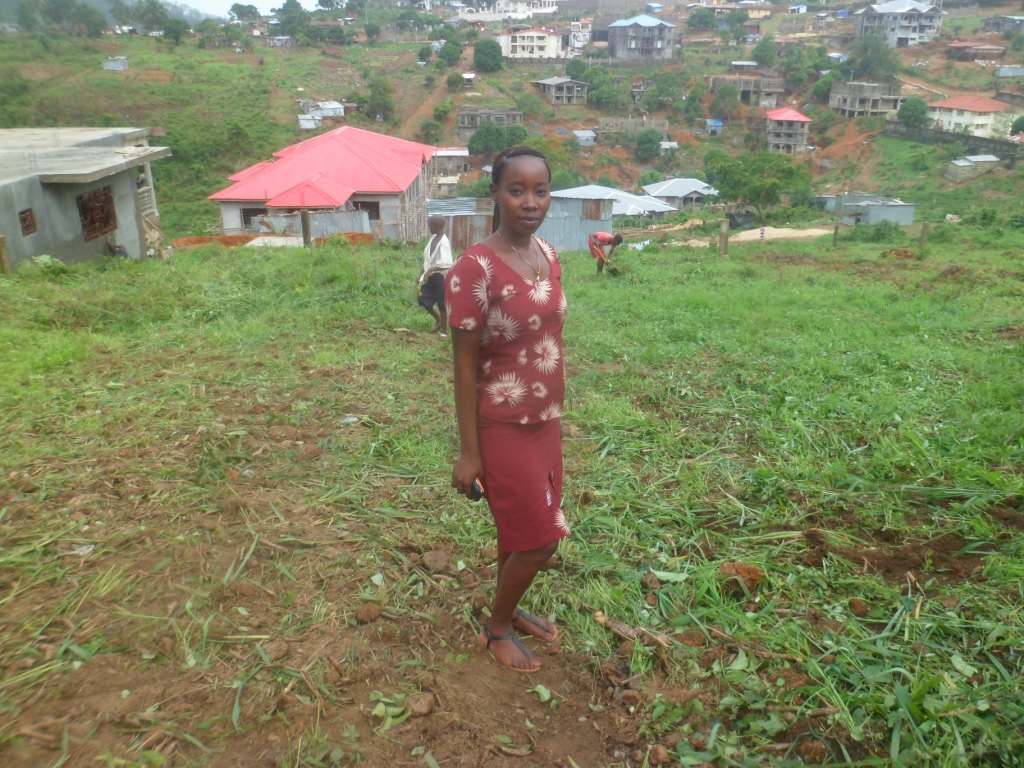 Head mistress standing on school land before work commence